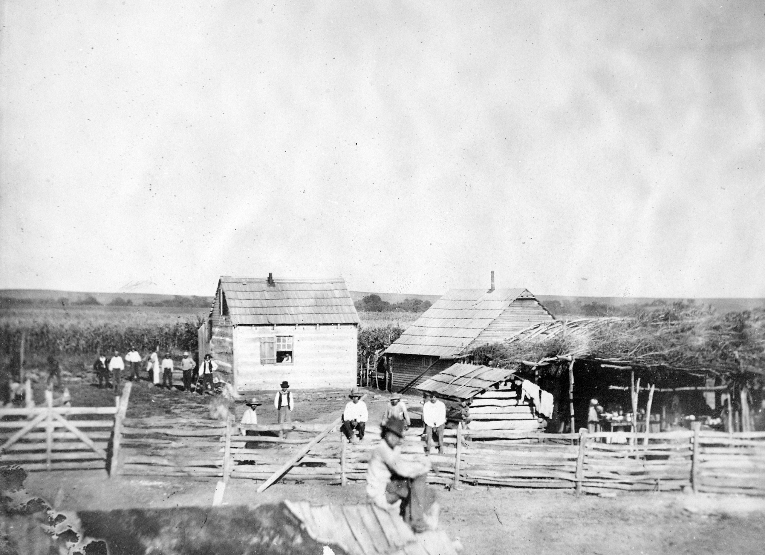 Pisehedwin, a Potawatomi, and others in front of his Kansas farm home. 1877